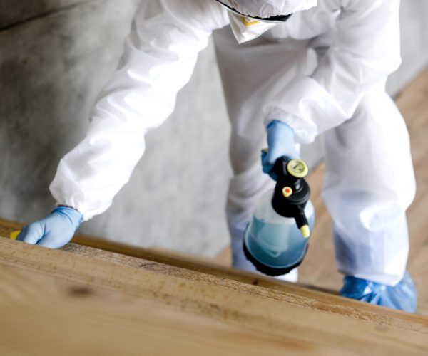 full-shot-man-with-suit-disinfecting-stairs